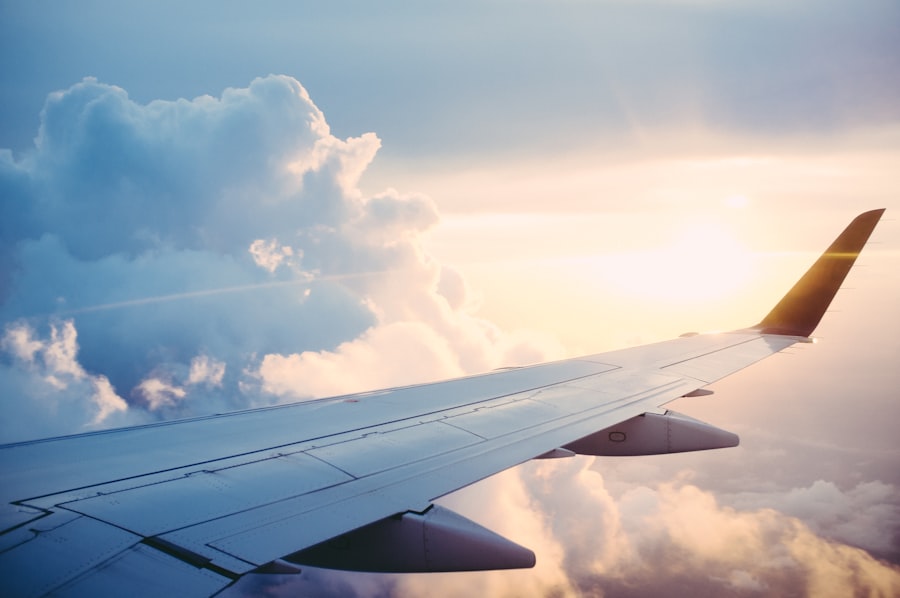 Traveler looking out an airplane window over the clouds